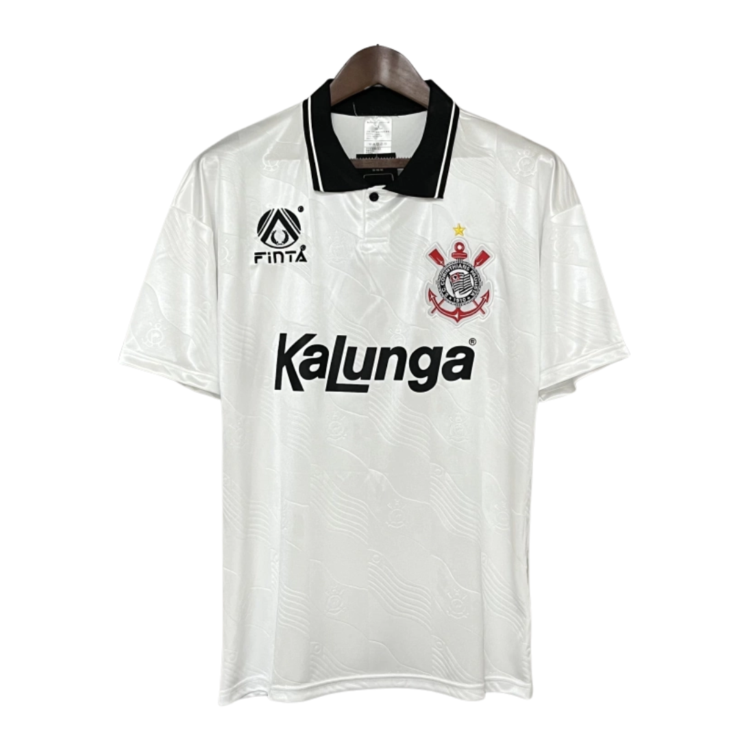 Em 1992, o Corinthians utilizou uniformes fornecidos pela marca brasileira Finta, com destaque para a camisa titular predominantemente branca. Esta peça apresentava gola polo preta e o logotipo da Finta no lado direito do peito, enquanto o escudo do clube ocupava o lado esquerdo. O patrocínio da Kalunga estava estampado no centro da camisa, reforçando a parceria da época. Este design clássico é lembrado com carinho pelos torcedores e colecionadores, simbolizando uma era significativa na história do clube.​